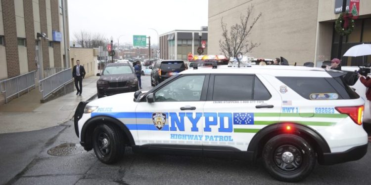 CEO shooting suspect shouts at press outside courthouse