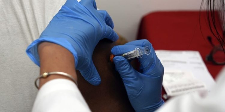 Doctors group recommends COVID vaccine for all adults in break with government